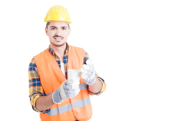 Young builder or constructor holding a cup of hot coffee — Stok fotoğraf