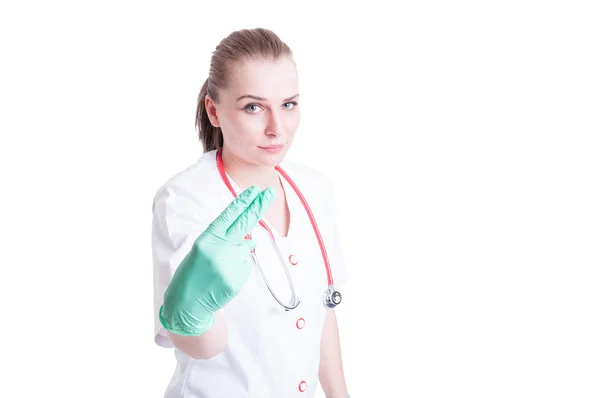 Woman doctor holding two fingers as penetration concept — ストック写真