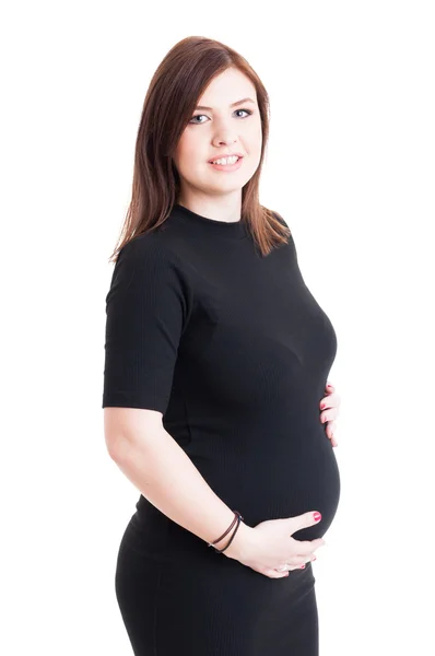 Porträtt av en vacker gravid håller hennes mage — Stockfoto