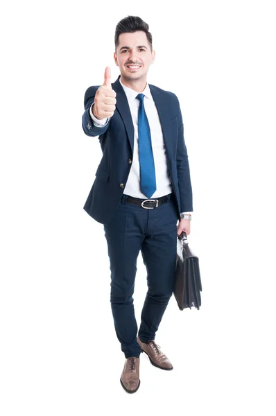 Confident businessman wearing blue suit and briefcase showing li — Stock Photo, Image