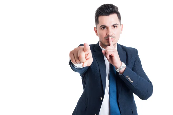 Confident businessman making keep a secret and silence gesture — Stock Photo, Image