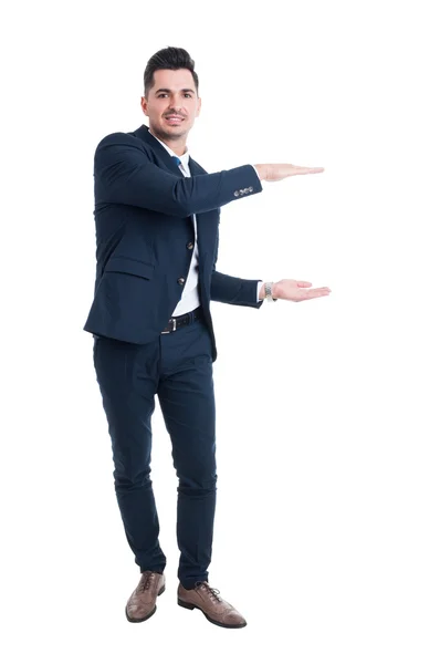 Smiling salesman holding copy space with hands — Stock Photo, Image