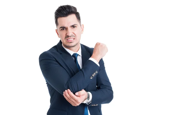 Injured businessman suffering of elbow pain — Stock Photo, Image