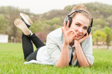 Rahat giysiler içinde Neşeli kadın ok işareti gösterir