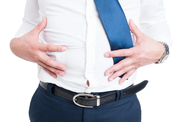 Businessman in closeup holds his stomach because of bloating — Stock Photo, Image