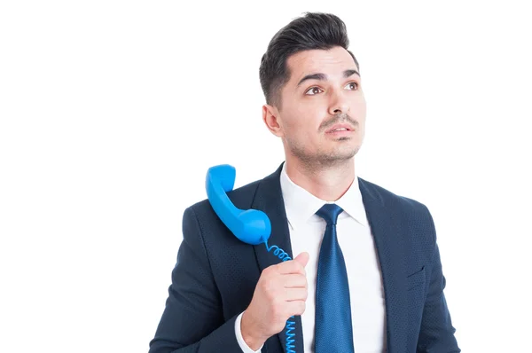 Young attractive businessman holding vintage phone on shoulder — Stock Photo, Image