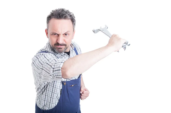 Angry mechanic acting violent with a steel wrench — Stock Photo, Image