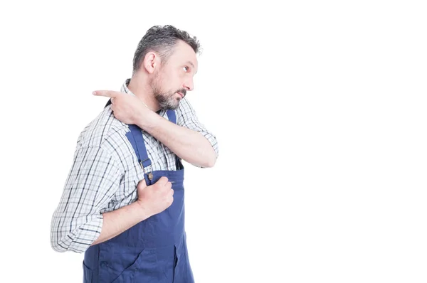 Young repairman putting overalls and getting ready for work — Stock Photo, Image