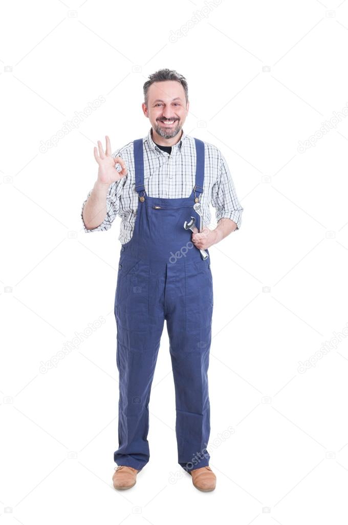 Trusthworthy mechanic showing ok gesture and smiling