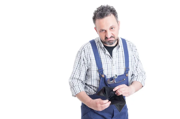 Portrait of unhappy mechanic with wrench holding empty wallet — Stock Photo, Image