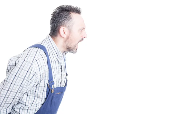 Side view of aggressive mechanic with mouth wide open — Stock Photo, Image