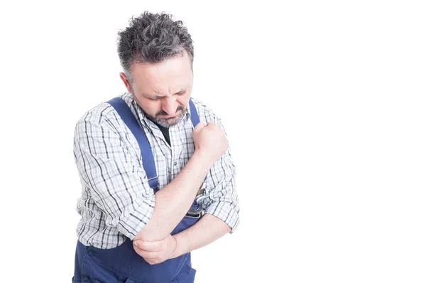 Portrait of young mechanic having pain in injured arm — Stock Photo, Image