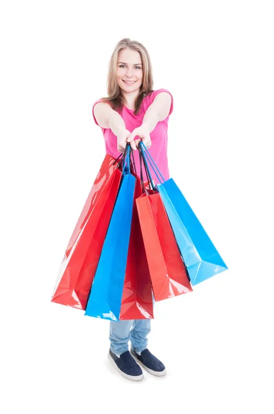 Woman holding lot of present paper bags acting joyful — Stock Photo, Image