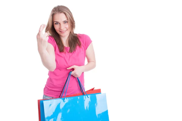 Portrait of beautiful young shopaholic with luck sign Stock Image