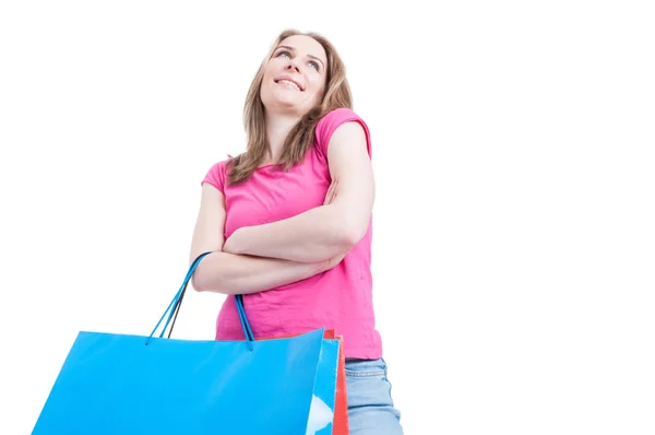 Low angle of happy shopaholic with shopping paper bags — Stock Photo, Image