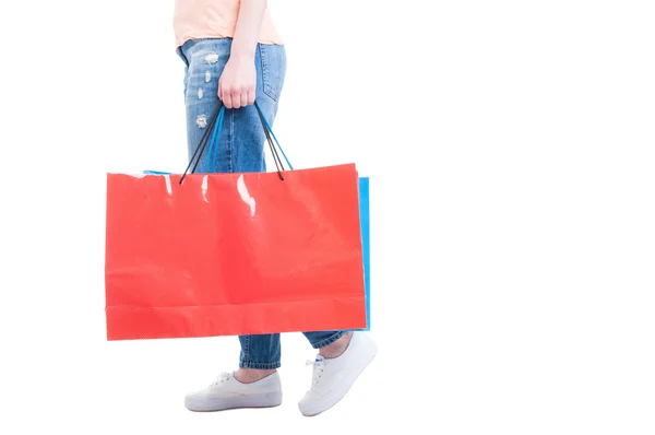 Vista lateral de la mujer caminando y llevando grandes bolsas de compras —  Fotos de Stock
