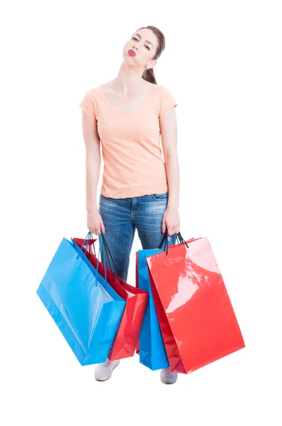 Young woman carrying heavy shopping bags feeling tired and exhau — Stock fotografie