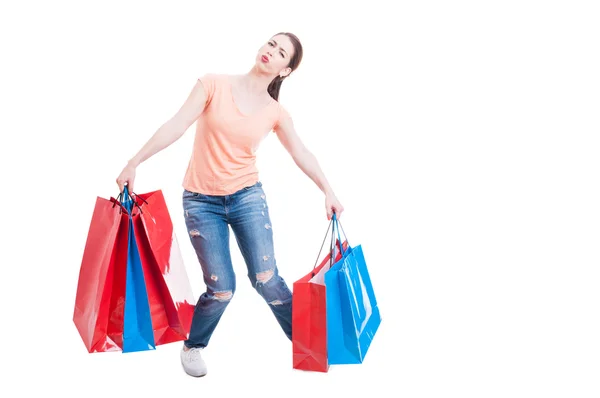 Young casual lady carrying heavy gift bags — ストック写真