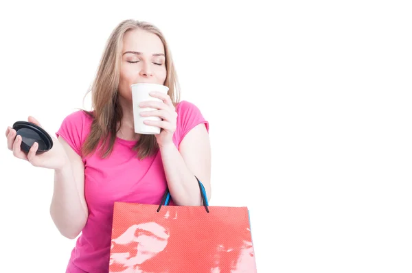 Portrait of beautiful young shopper smelling and enjoying coffee — Stock Photo, Image