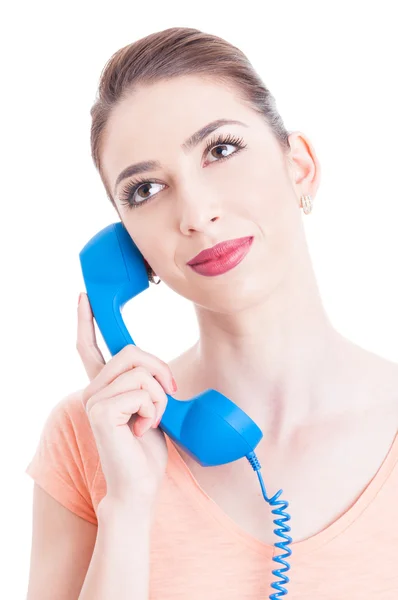 Portrait of young attractive woman holding telephone receiver — Stock Photo, Image
