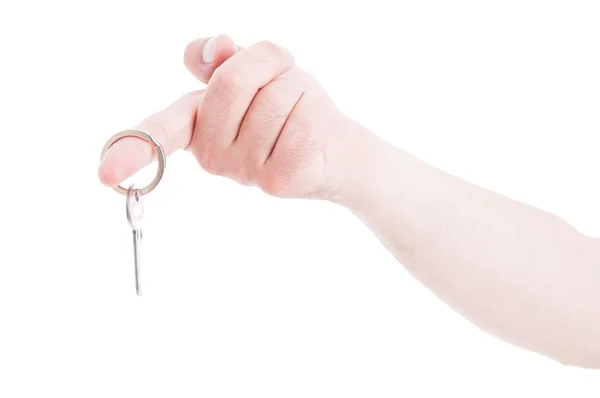 Männliche Hand hält Schlüsselanhänger am Zeigefinger als Immobilien — Stockfoto