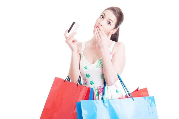 Nakupující žena hledá překvapen drží kreditní nebo debetní kartou — Stock fotografie