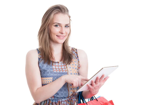 Attractive smiling female using digital tablet to do shopping on — Stock Photo, Image
