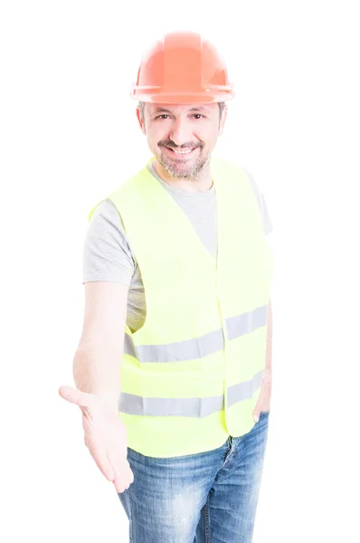 Amistoso trabajador de la construcción sonriendo y haciendo un apretón de manos gest —  Fotos de Stock