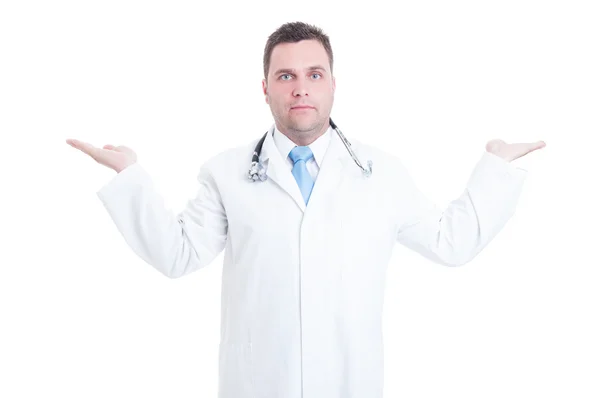 Young male doctor holding copyspace with two hands isolated — Stockfoto
