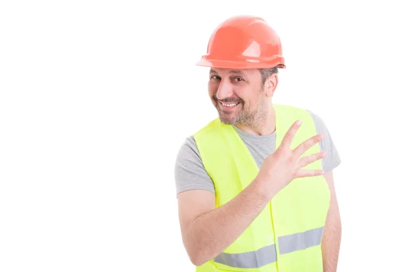 Bonito construtor segurando quatro dedos para cima e sorrindo — Fotografia de Stock