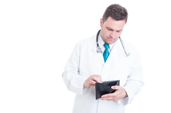 Male medic looking in his empty wallet — Stock Photo, Image