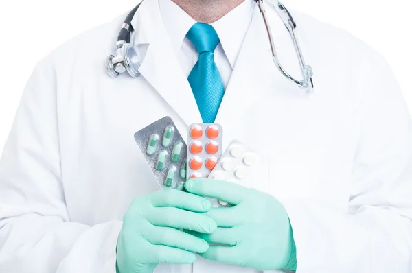 Close-up of male medic holding handful of blisters — Stock Photo, Image