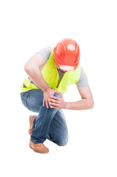 Male constructor kneeling and suffering from knee pain — Stock Photo, Image