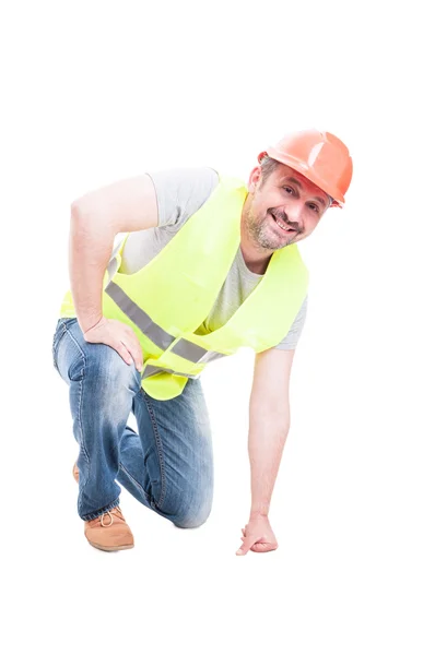 Smiling attractive constructor kneeling on the floor — Stock Photo, Image