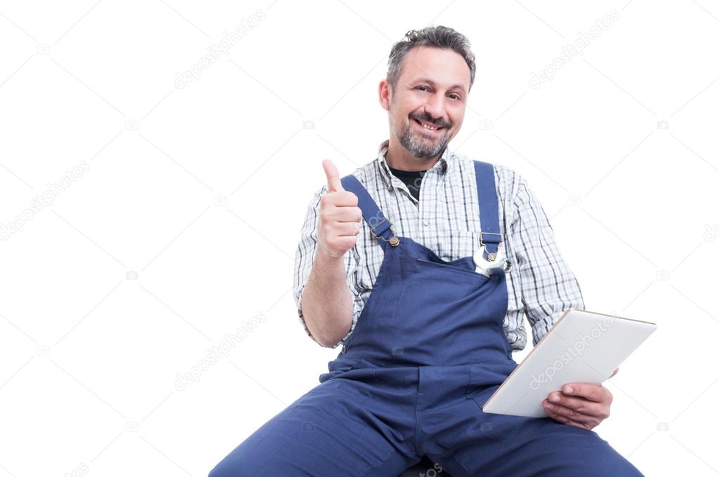 Attractive smiling mechanic showing thumb up gesture
