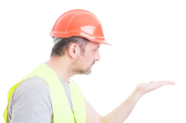 Portrait of attractive constructor looking at his palm — Stock Photo, Image