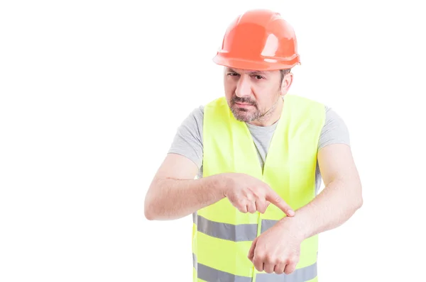 Angry male engineer pointing at his wrist — Stock Photo, Image