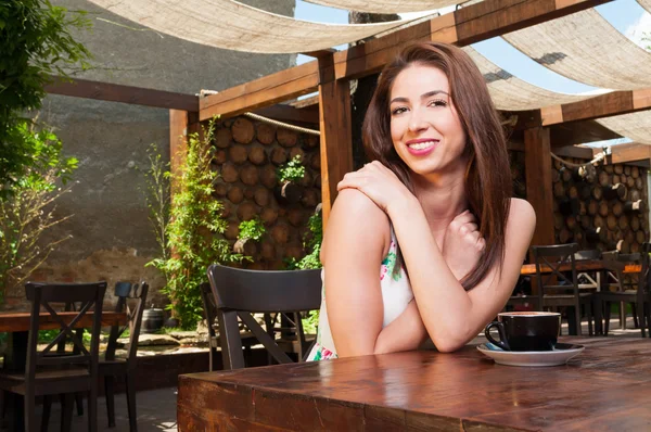 Lady smiling outside on terrace having coffee — Stock Photo, Image