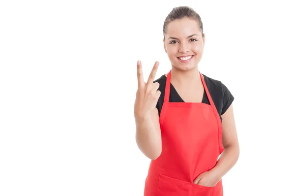 Beautiful young saleswoman on hypermarket counting two — Stock Photo, Image