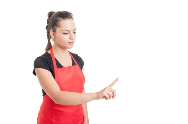 Beautiful supermarket employee pointing finger to something — Stock Photo, Image