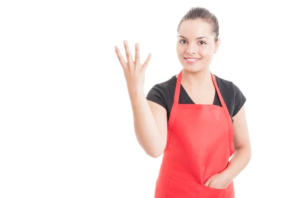 Pretty supermarket employee showing number four — Stock Photo, Image