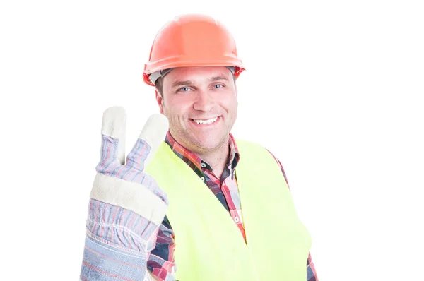 Bonito construtor sorrindo contando dois — Fotografia de Stock