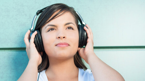 Pretty girl smiling holding her headphones