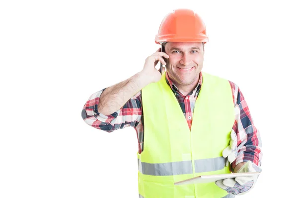 Gutaussehender Bauunternehmer hält Tablet und ruft jemanden an — Stockfoto