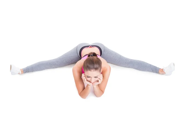 Vista arriba de la chica en forma sentada con la pierna extendida —  Fotos de Stock