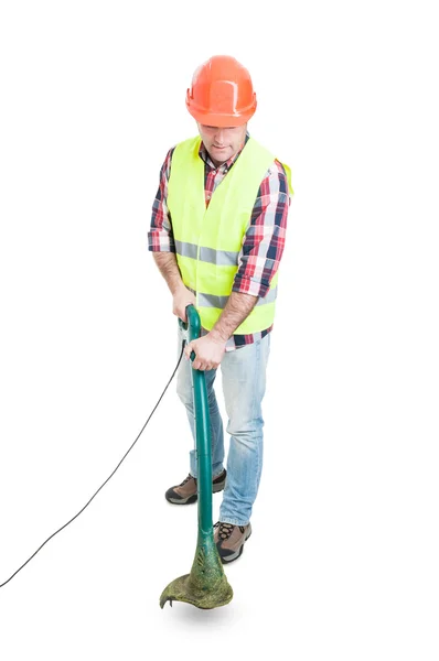 Male constructor using lawn mower for cutting grass — Stock Photo, Image