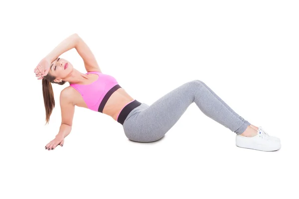 Woman at gym sitting down tired after workout — Stockfoto