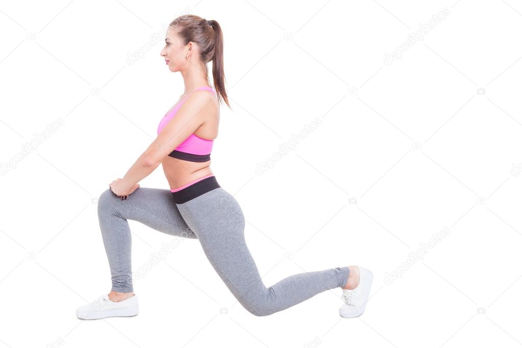 Young female working out standing in lunge position
