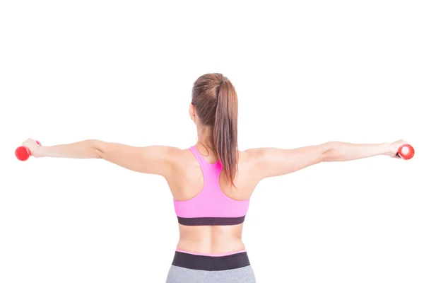 Rückansicht einer Frau im Fitnessstudio beim Hantelheben — Stockfoto