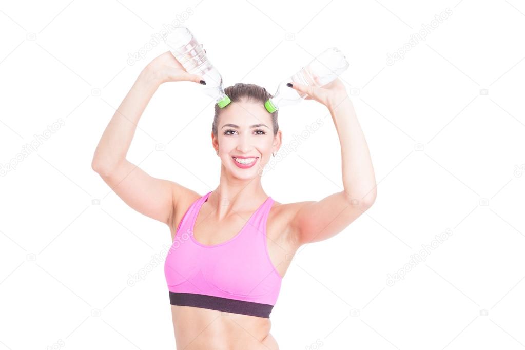 Woman at gym making horns with water bottles
